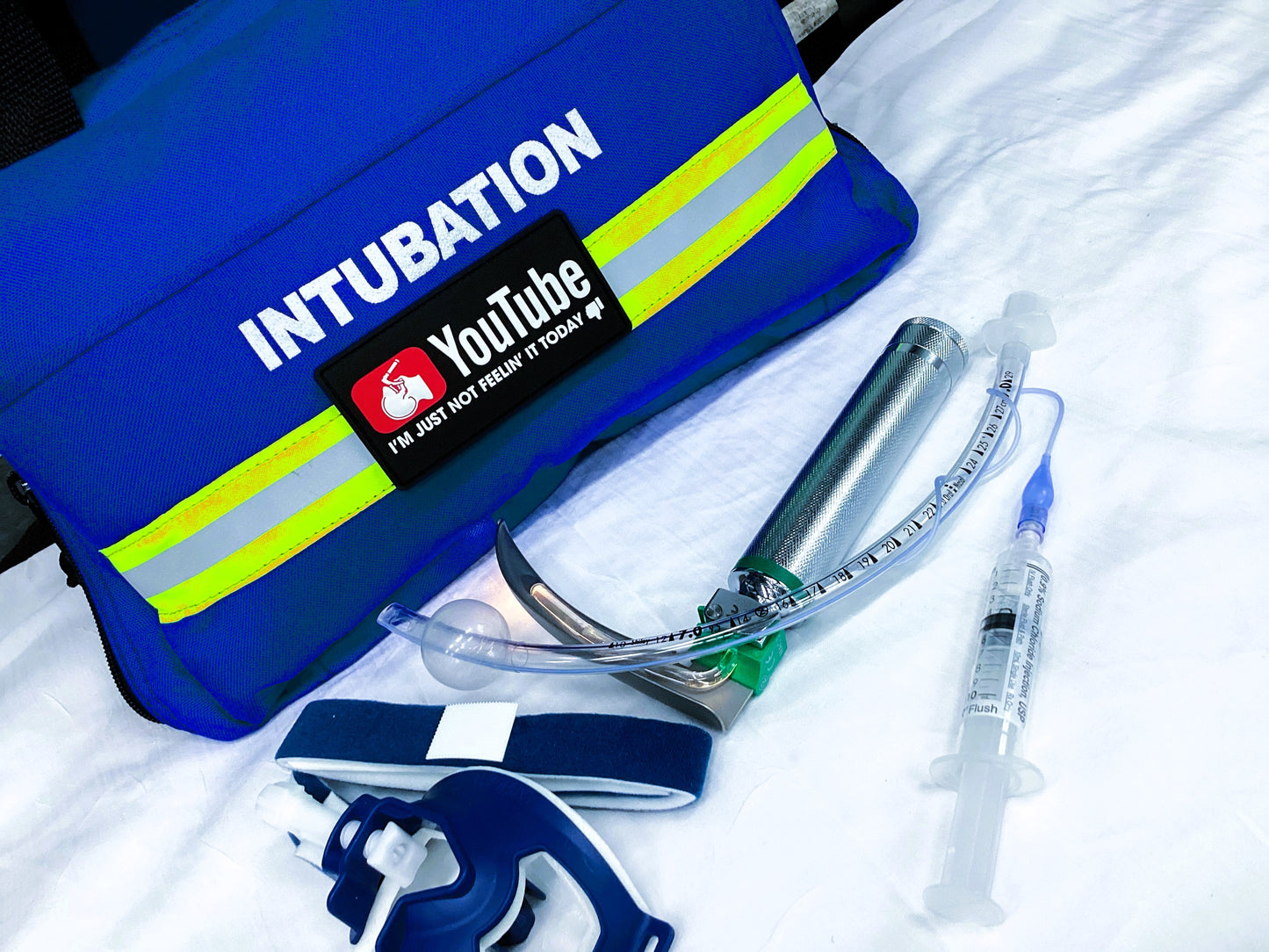 YouTube Intubation patch attached to a blue intubation kit and other intubation equipment.