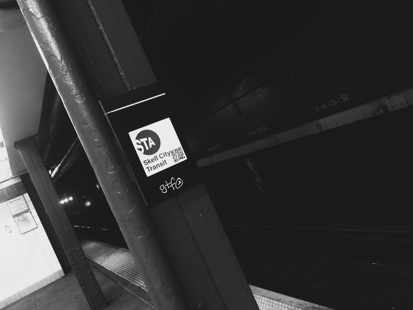 Metropolitan transportation authority skell city station sticker stuck to subway platform street plaque.