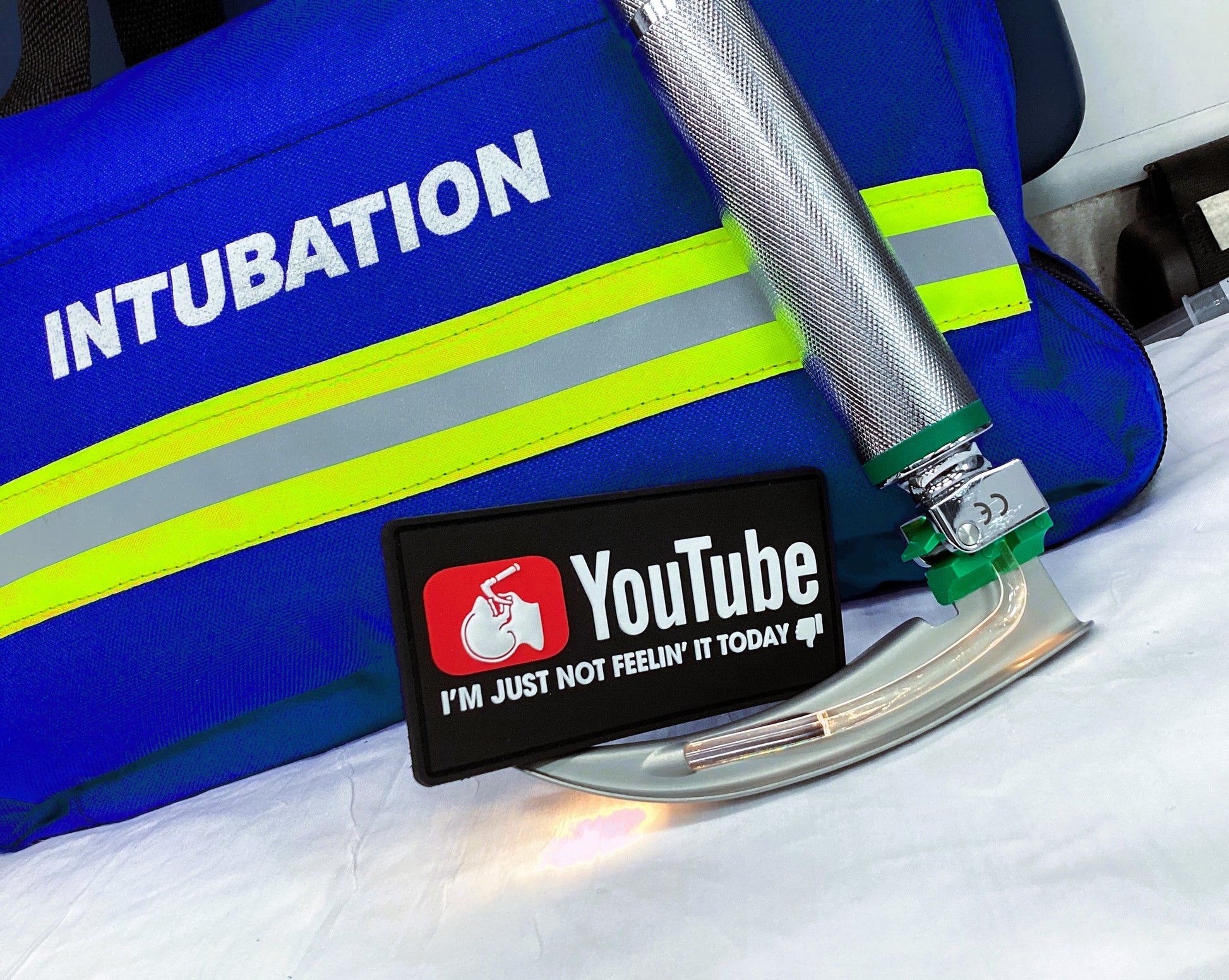 YouTube Intubation patch sitting on top of a MAC 3 laryngoscope blade with handle.