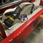 Fire Department of new York patch logo from skell city leaning against fire hose and nozzle.