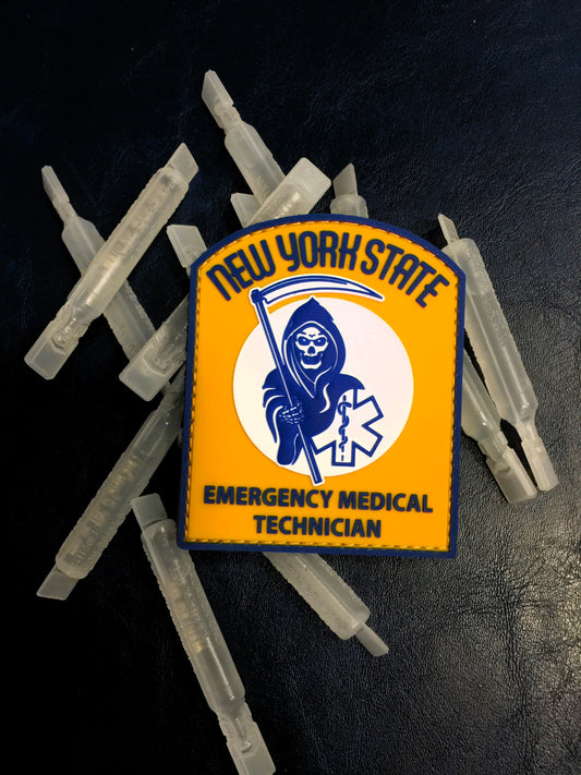 New York State EMT Patch from skellcity lying on top of plastic albuterol vials.