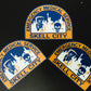 New York City EMS Health and Hospitals Corporation patch in reflective stickers in a crescent formation, against a black background. 