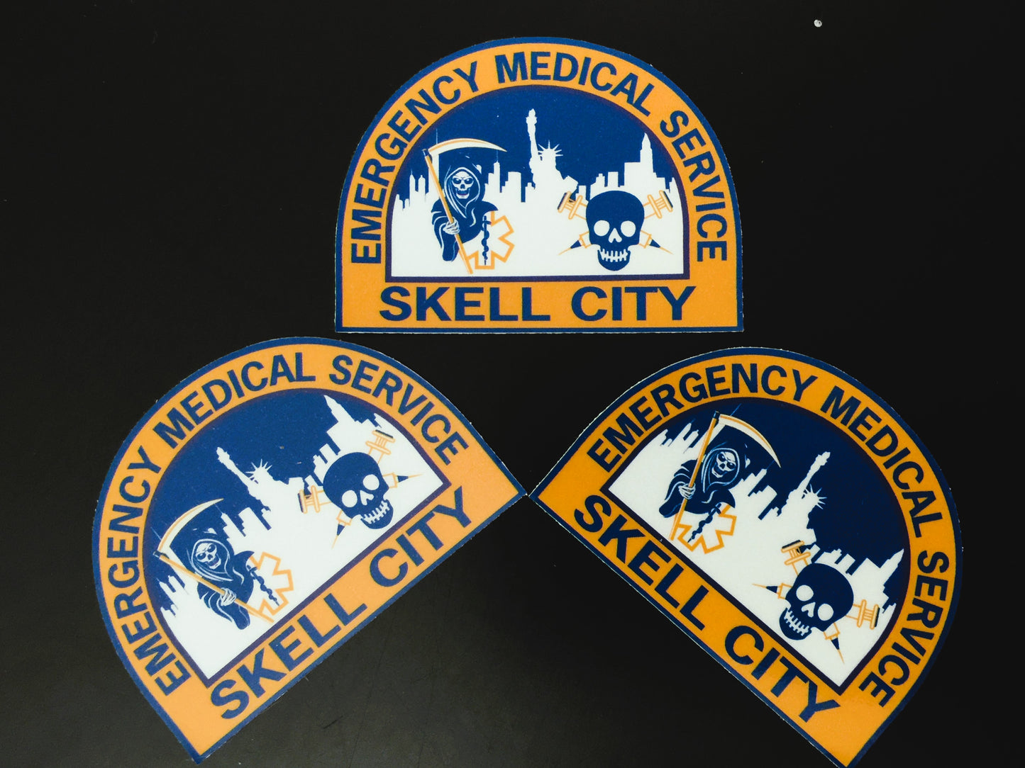 New York City EMS Health and Hospitals Corporation patch in reflective stickers in a crescent formation, against a black background. 