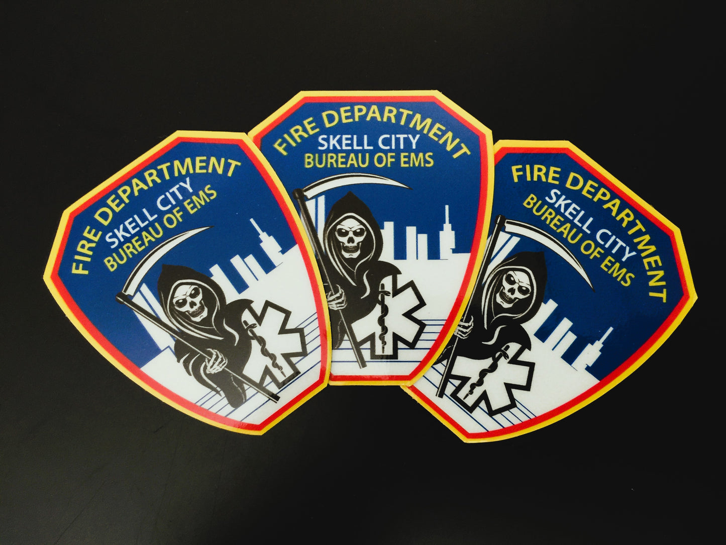 FDNY Bureau Of Emergency Medical Services patch reflective stickers from skellcity.com, in a fan formation against a solid black background.