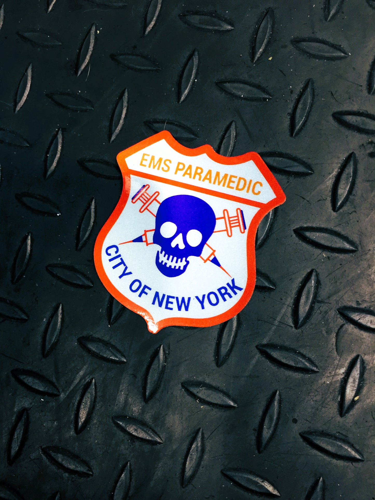 NYC skell city EMS Paramedic patch reflective sticker on steel grid background