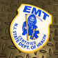 New Jersey EMT PVC Velcro Patch, from Skell City, up against gray gridiron background.