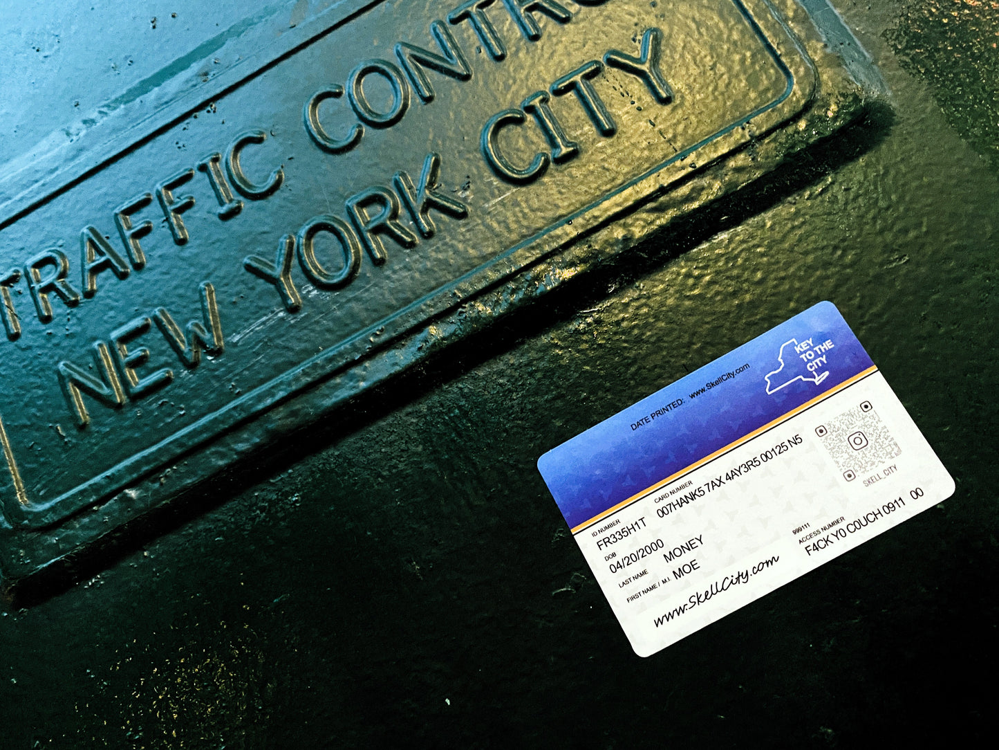 skell city 'key to the city' sticker card with qr code up against green new York city traffic control light relay box. The card looks similar to the New York state medicaid card.