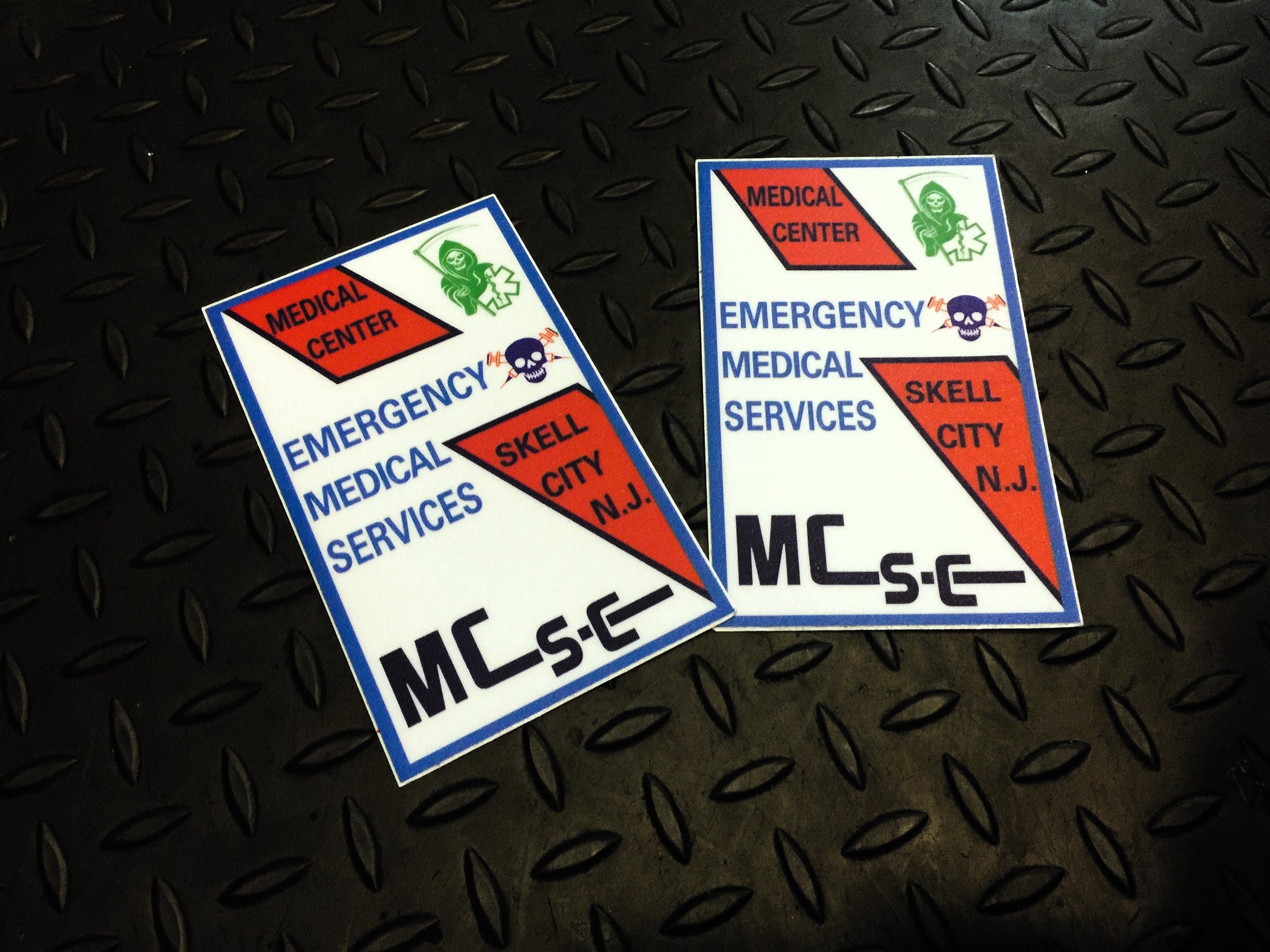 Jersey City Medical Center Patch Stickers, from skell city, against a gray gridiron background.