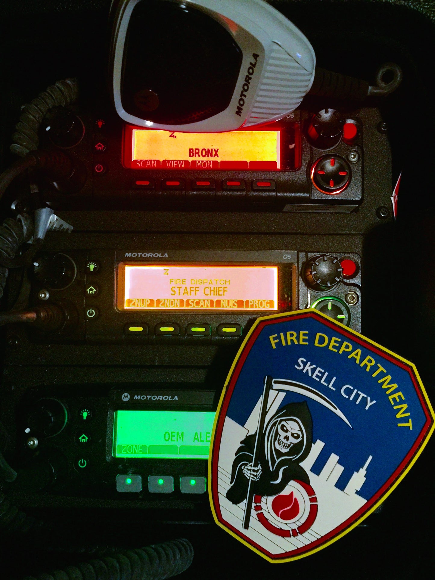 FDNY Firefighter patch from skell city next to Motorola radio transceivers.