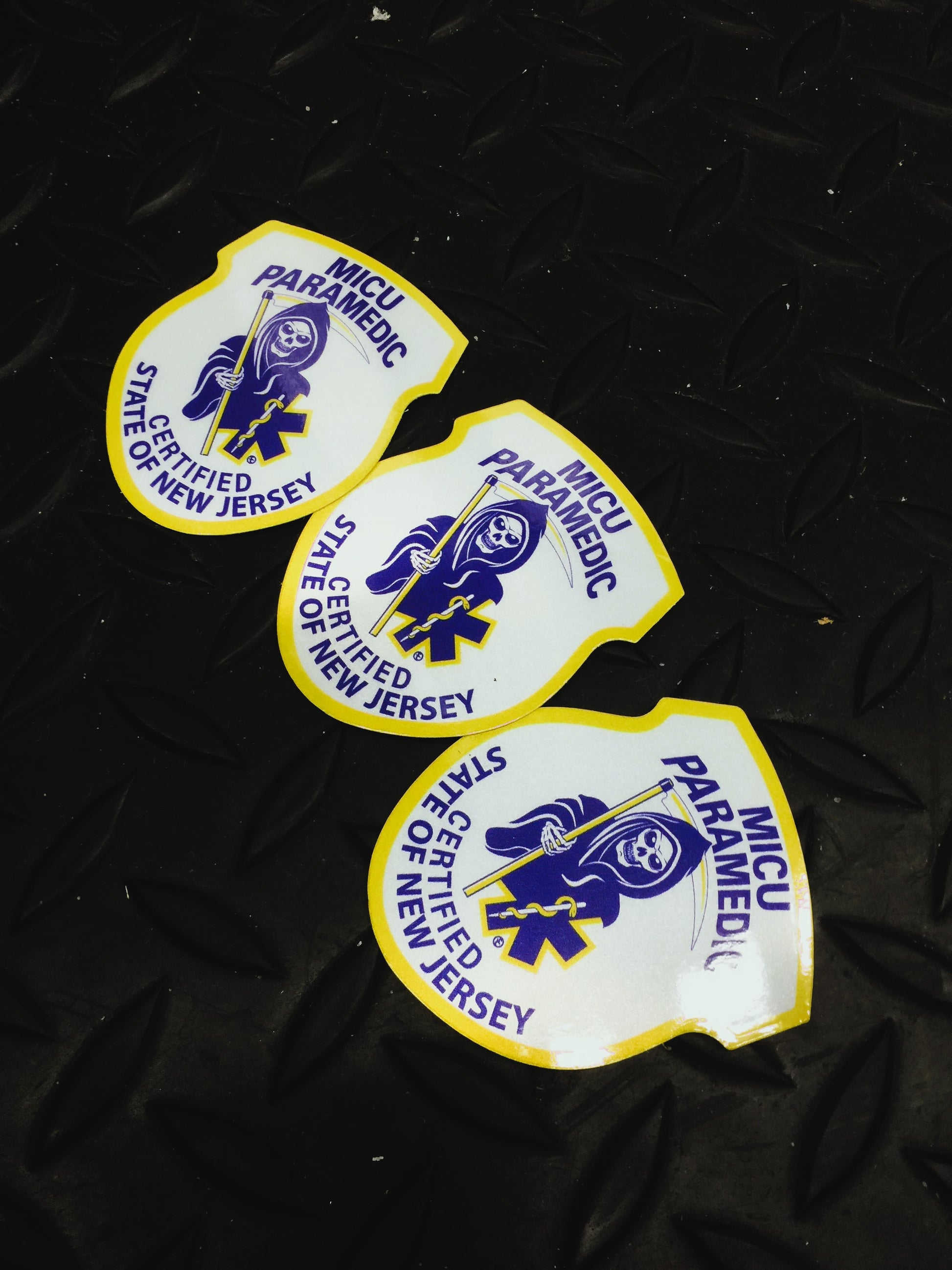 New Jersey MICU Paramedic Patch reflective stickers in descending order against a pitch black gridiron background.