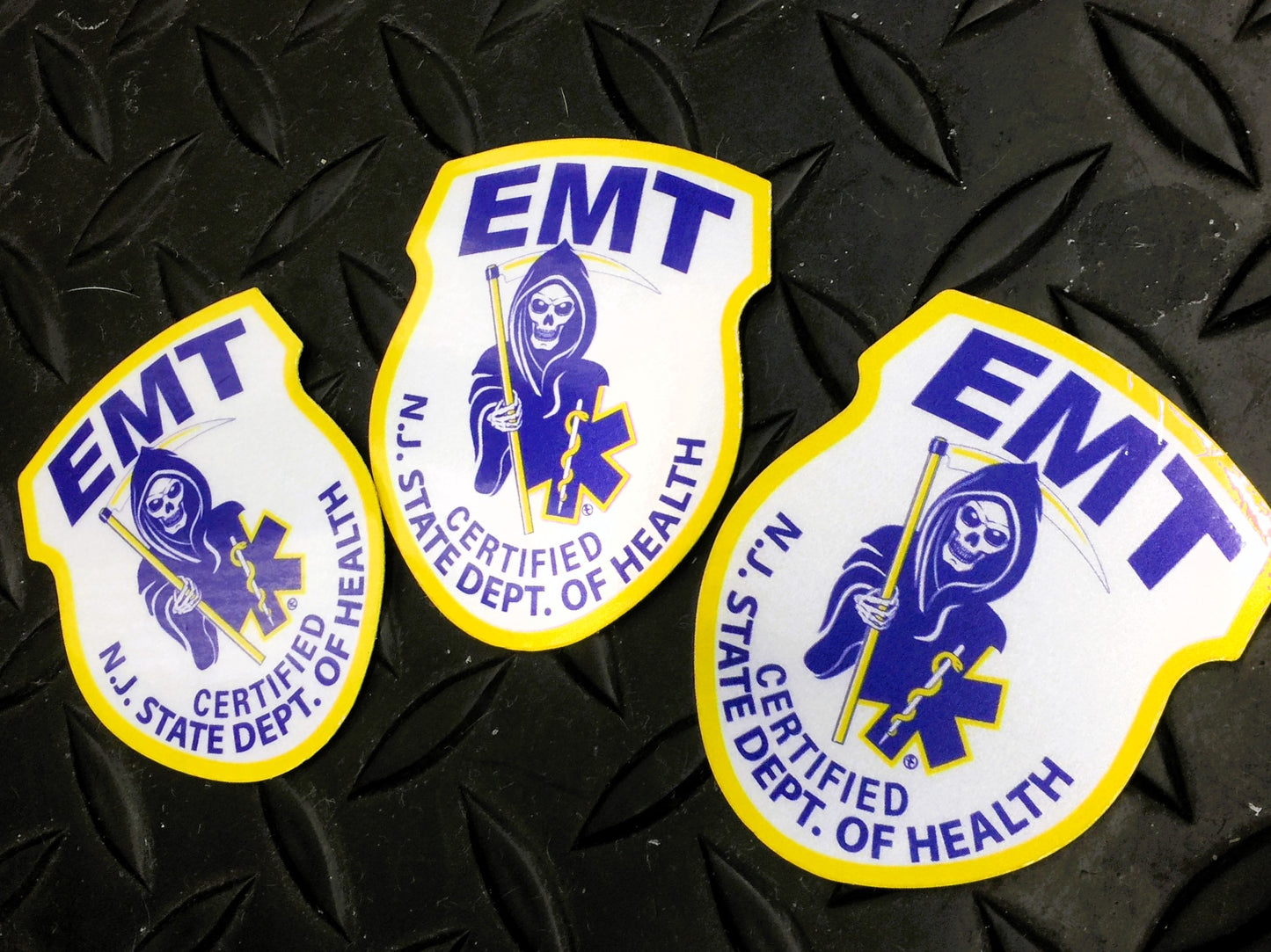 New Jersey EMT patch Reflective Helmet Stickers from skellcity.com against Black gridiron background.