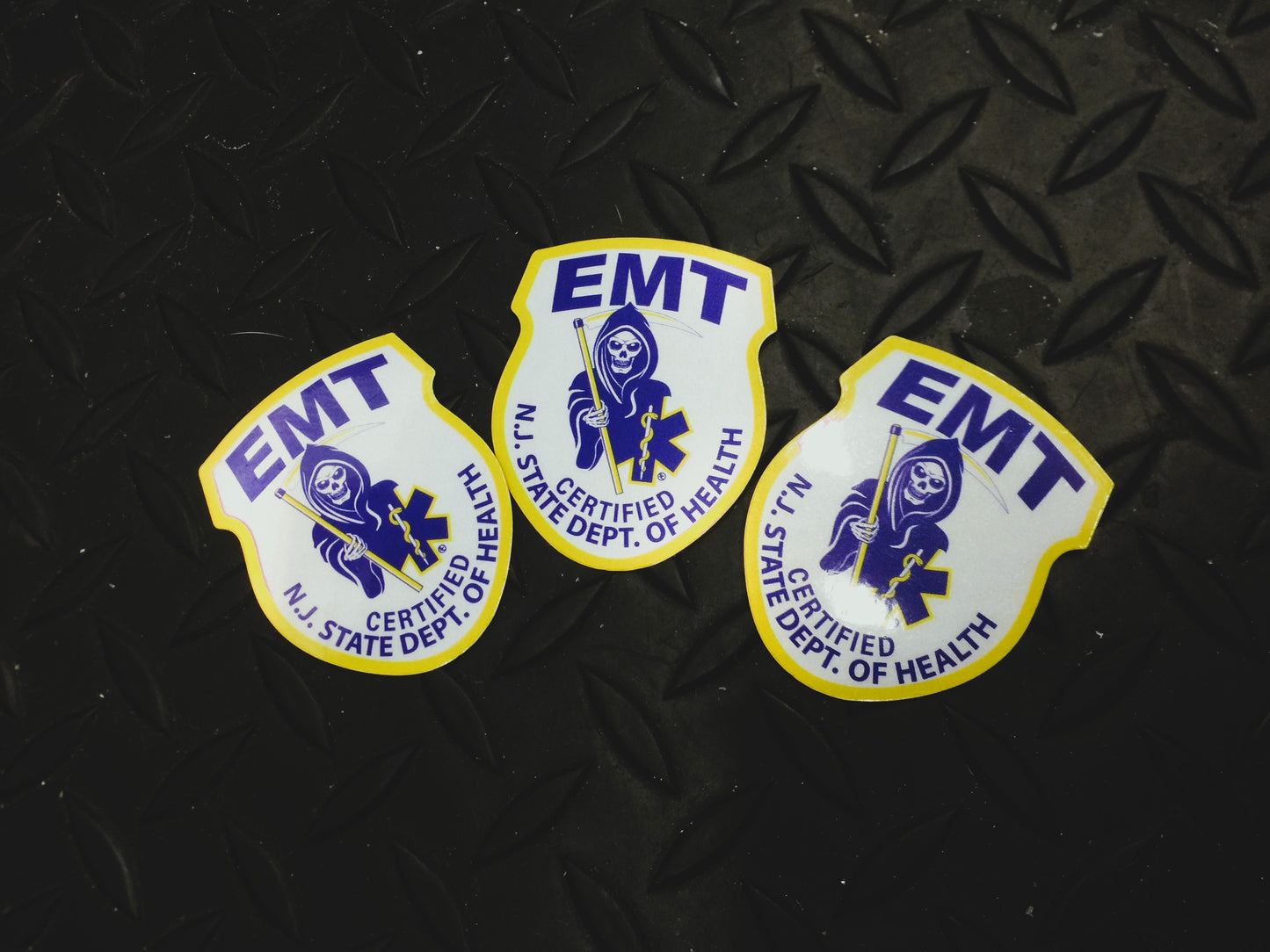 New Jersey EMT patch Reflective Helmet Stickers against Black gridiron background.