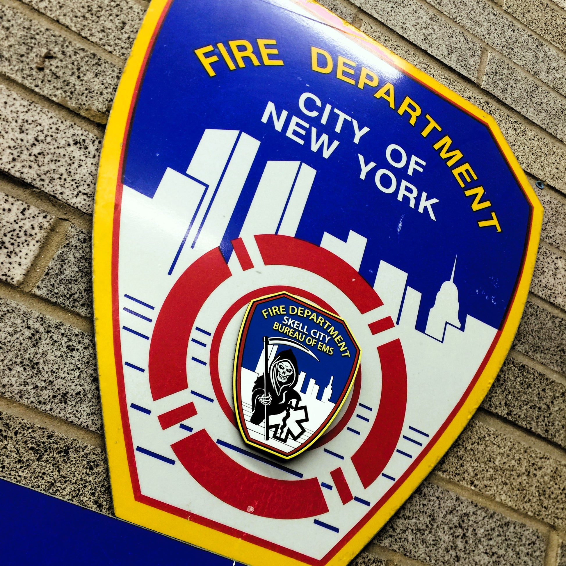 FDNY logo with skell city EMS patch attached to the middle of design.