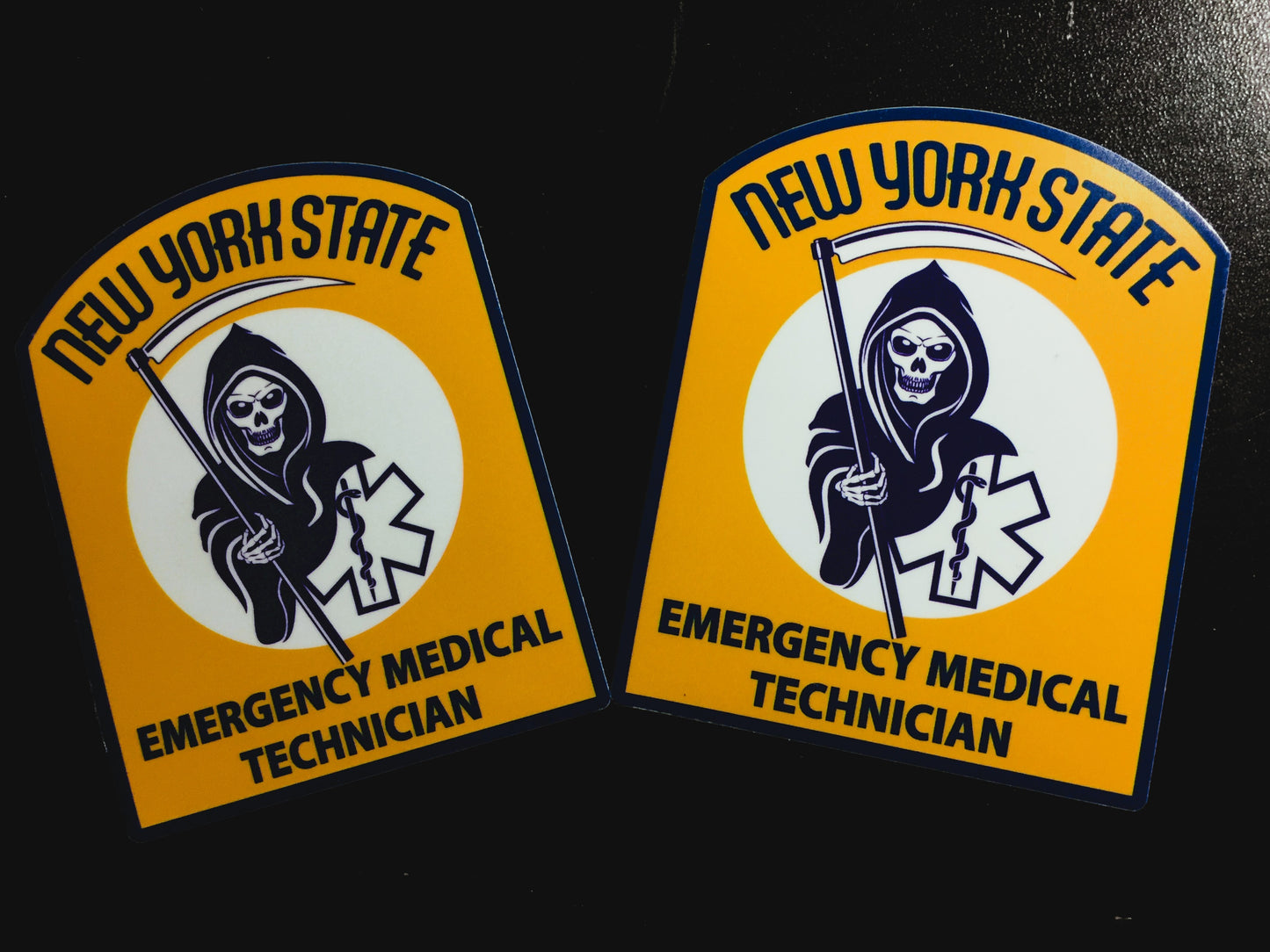 NYS EMT Patch glossy stickers from skell city, against a black background.