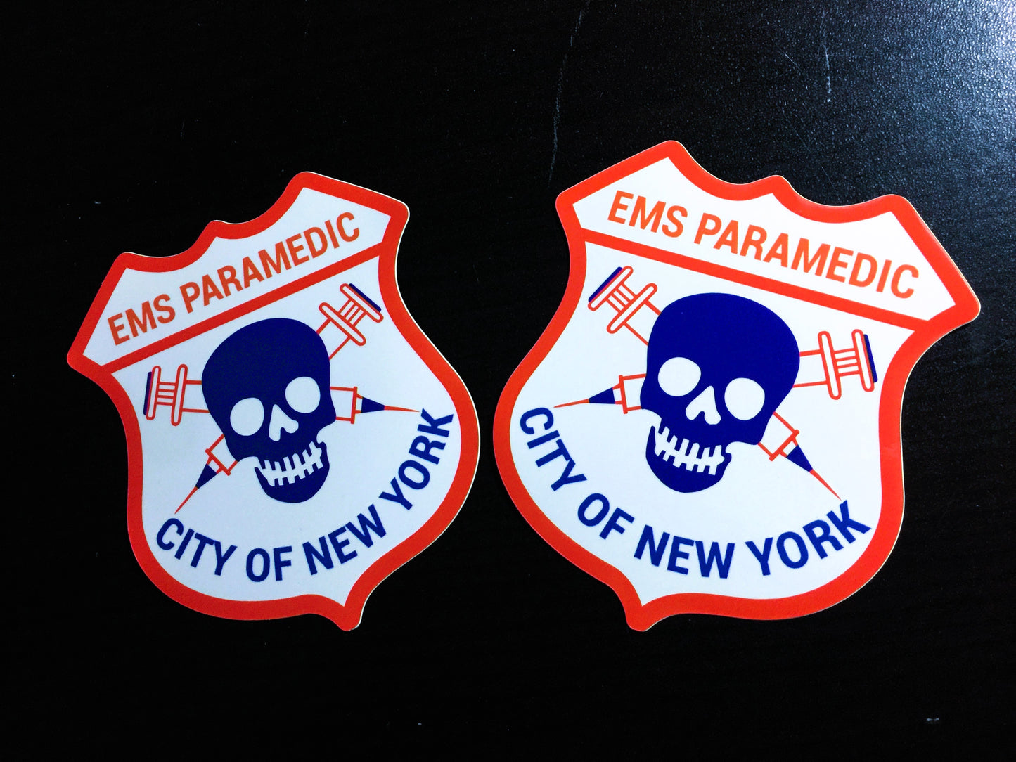 New York City Paramedic Patch Glossy Stickers against a Black background.