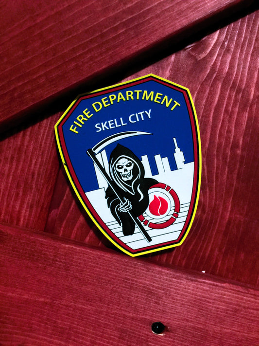 FDNY firefighter Patch from skell city up against red wooden firehouse door.