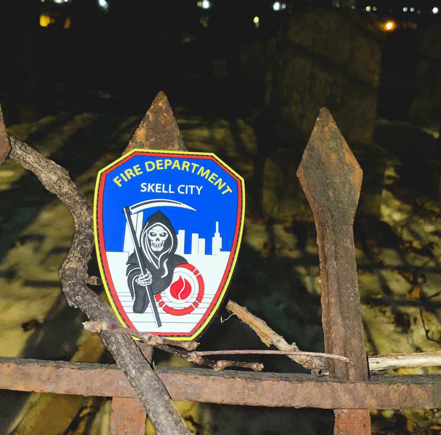 FDNY Firefighter patch on an old rusted iron fence, inside of graveyard.