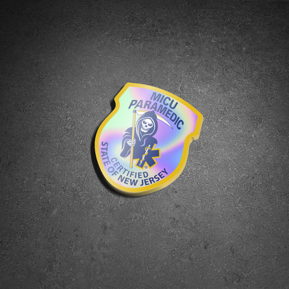 New jersey MICU Paramedic patch Holographic Sticker from skellcity on a concrete street background.